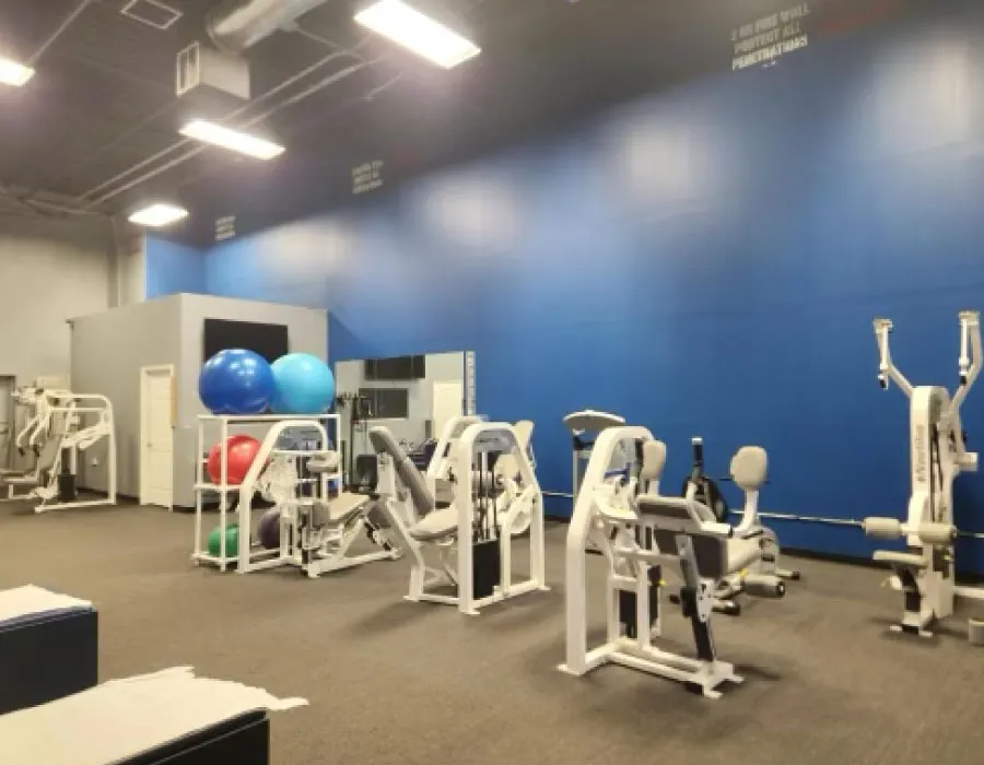 Rehab gym with exercise machines and therapy balls at a Doc Tony clinic