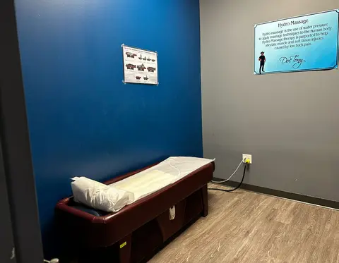 Private treatment table in a blue-walled room