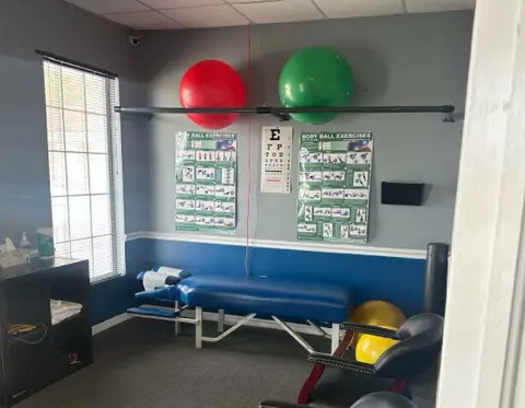 Treatment room with exercise balls and an eye chart